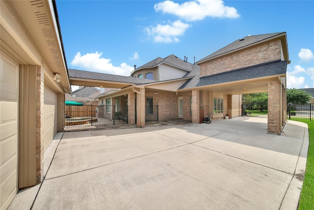 5714 Spring River Ln, Fulshear, TX 77441 - exterior space with brick siding, a shingled roof, and a patio