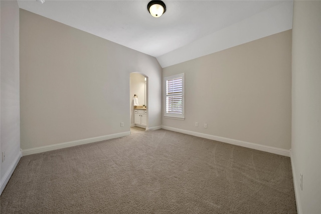 5714 Spring River Ln, Fulshear, TX 77441 - unfurnished room with arched walkways, baseboards, lofted ceiling, and light colored carpet