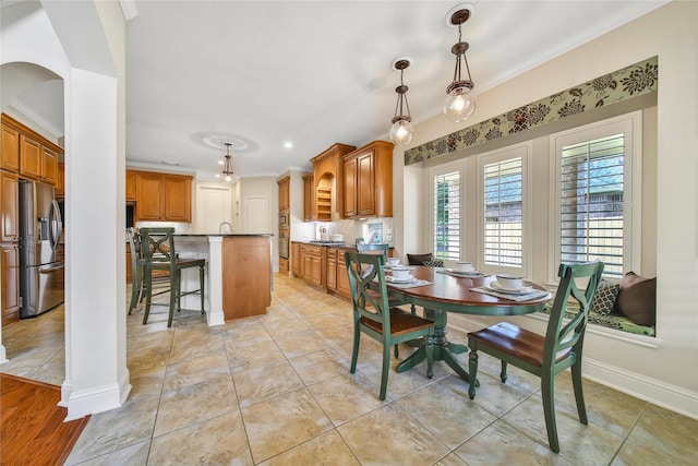 5714 Spring River Ln, Fulshear, TX 77441 - dining space featuring ornamental molding, baseboards, and arched walkways