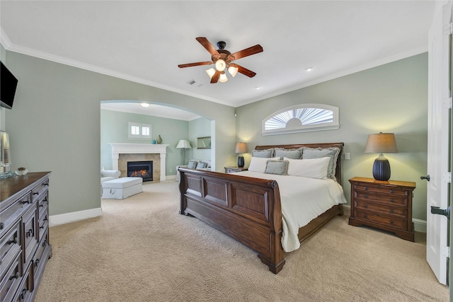 5714 Spring River Ln, Fulshear, TX 77441 - bedroom with a premium fireplace, light colored carpet, arched walkways, baseboards, and ornamental molding