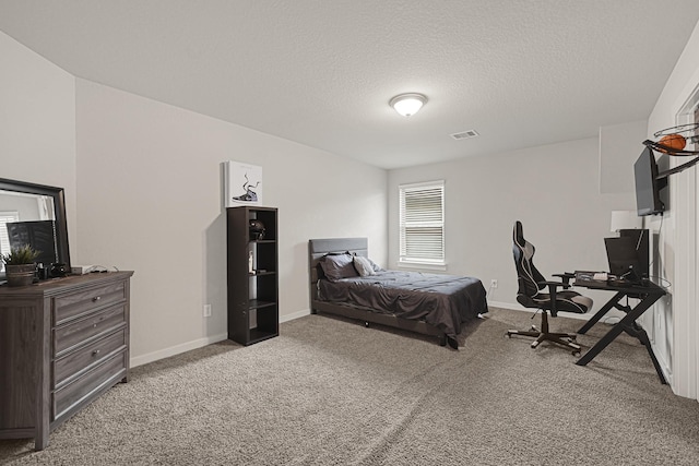carpeted bedroom featuring a textured ceiling, baseboards, and an office area