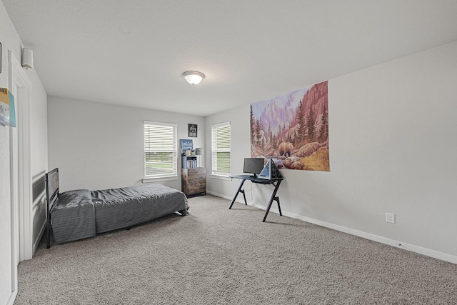 carpeted bedroom with baseboards