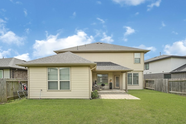 back of property featuring a patio area and roof with shingles