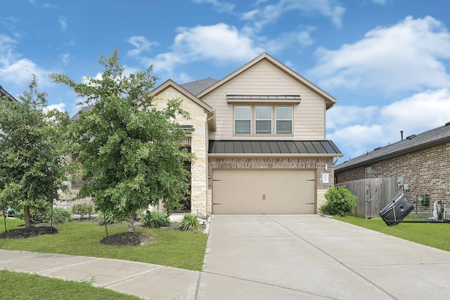 view of front of property with a standing seam roof, concrete driveway, an attached garage, stone siding, and metal roof