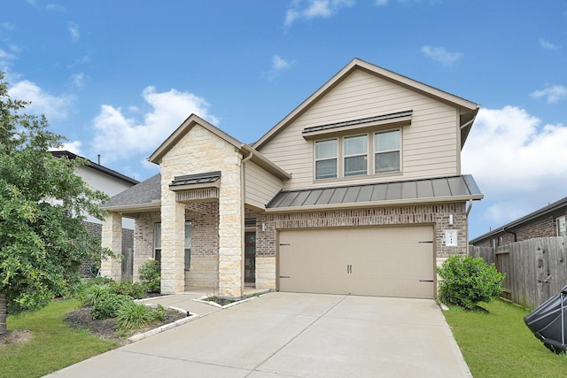 view of front of property featuring stone siding, a standing seam roof, concrete driveway, an attached garage, and metal roof