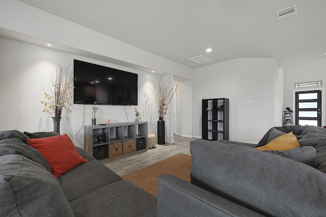 living room with wood finished floors and recessed lighting