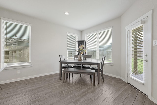 dining room featuring wood finished floors, baseboards, and recessed lighting
