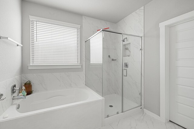 full bath with marble finish floors, a marble finish shower, a bath, and baseboards