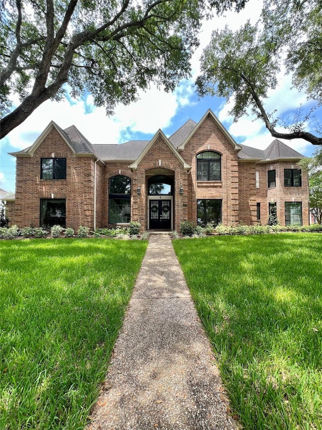 1602 Kelliwood Oaks Dr, Katy, TX 77450 - view of front of house with brick siding, a front yard, and french doors