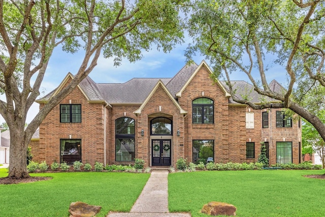 1602 Kelliwood Oaks Dr, Katy, TX 77450 - view of front of home featuring french doors, brick siding, a front lawn, and a shingled roof