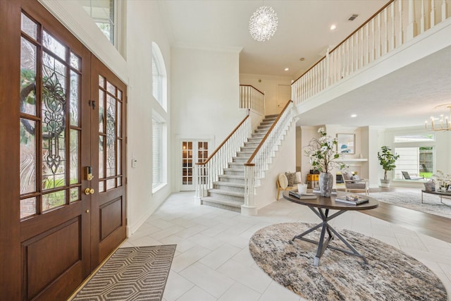 1602 Kelliwood Oaks Dr, Katy, TX 77450 - foyer entrance featuring a high ceiling, a chandelier, stairs, french doors, and crown molding