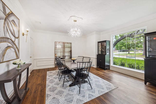 1602 Kelliwood Oaks Dr, Katy, TX 77450 - dining area featuring a chandelier, wood finished floors, crown molding, and wainscoting