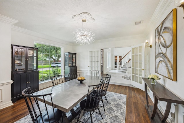 1602 Kelliwood Oaks Dr, Katy, TX 77450 - dining space with dark wood finished floors, ornamental molding, a chandelier, and wainscoting