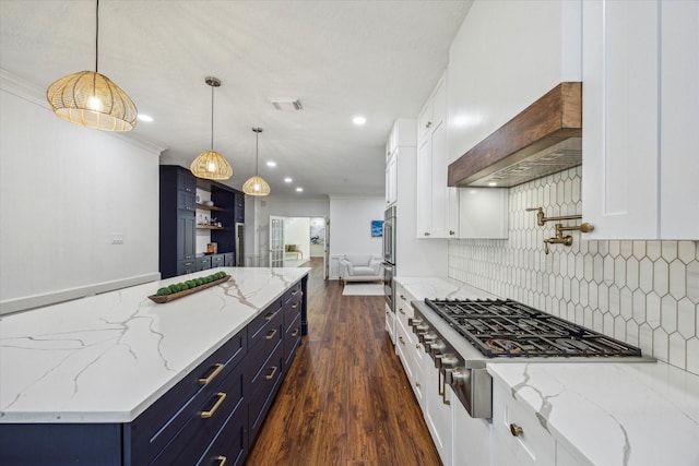 1602 Kelliwood Oaks Dr, Katy, TX 77450 - kitchen with open floor plan, stainless steel gas cooktop, white cabinets, blue cabinetry, and decorative backsplash