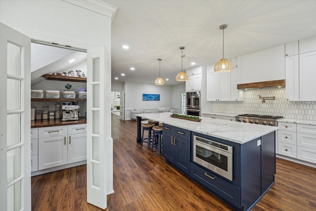 1602 Kelliwood Oaks Dr, Katy, TX 77450 - kitchen with stainless steel appliances, white cabinets, blue cabinetry, and recessed lighting