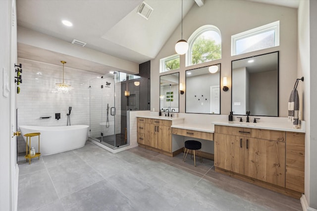 1602 Kelliwood Oaks Dr, Katy, TX 77450 - full bath with a freestanding bath, a shower stall, vanity, high vaulted ceiling, and concrete floors