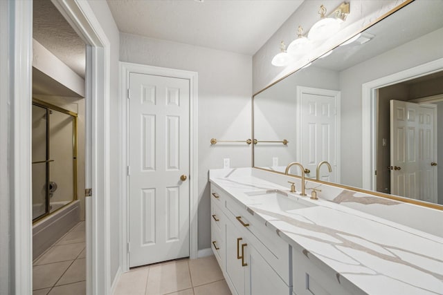1602 Kelliwood Oaks Dr, Katy, TX 77450 - full bathroom with vanity, tile patterned flooring, shower / bath combination with glass door, and baseboards