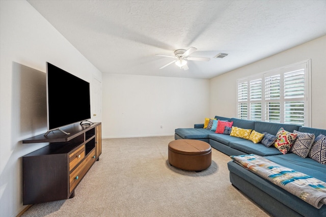 1602 Kelliwood Oaks Dr, Katy, TX 77450 - living room featuring light colored carpet, a ceiling fan, and a textured ceiling