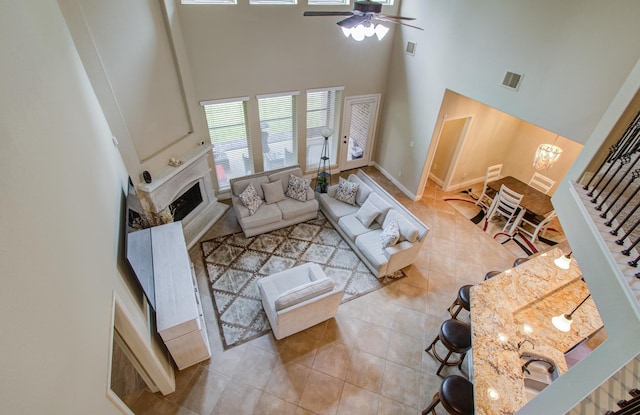 3539 Vasser Ridge Dr, Spring, TX 77388 - tiled living room with a high ceiling, ceiling fan, a fireplace, and baseboards