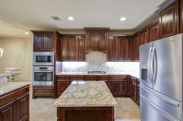 3539 Vasser Ridge Dr, Spring, TX 77388 - kitchen featuring appliances with stainless steel finishes, light tile patterned floors, decorative backsplash, light stone counters, and recessed lighting