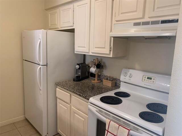 10075 Westpark Dr Unit 43, Houston, TX 77042 - kitchen with white appliances, under cabinet range hood, white cabinets, light tile patterned floors, and dark countertops
