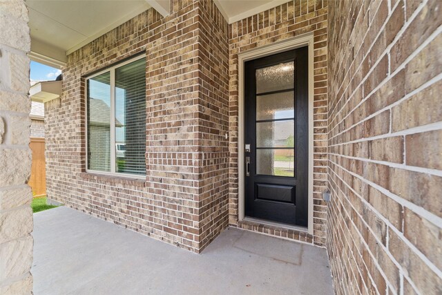 12206 English Mist Dr, Houston, TX 77044 - property entrance with brick siding and a porch