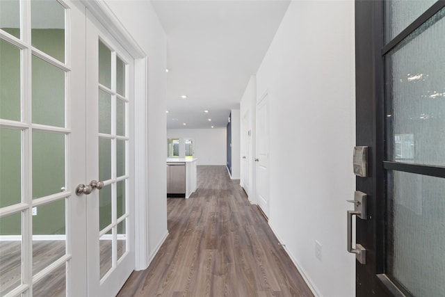 12206 English Mist Dr, Houston, TX 77044 - hallway with dark wood-style flooring, french doors, baseboards, and recessed lighting