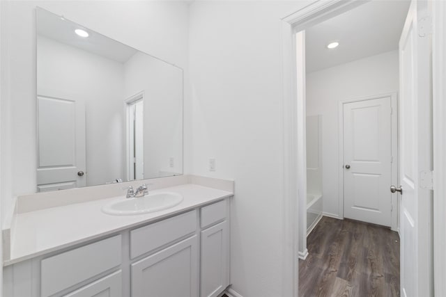 12206 English Mist Dr, Houston, TX 77044 - bathroom featuring vanity, wood finished floors, a bathtub, and recessed lighting