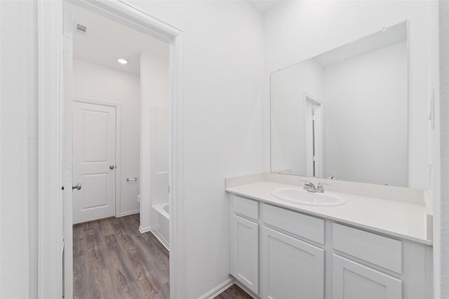 12206 English Mist Dr, Houston, TX 77044 - full bathroom featuring vanity, wood finished floors, and a tub