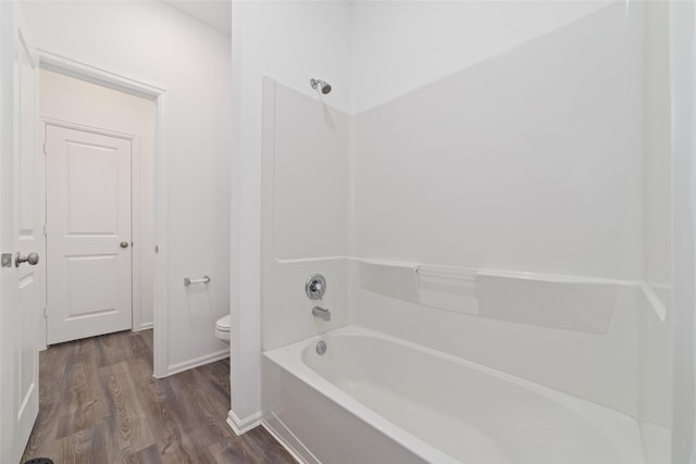 12206 English Mist Dr, Houston, TX 77044 - full bath with wood finished floors, toilet, shower / bath combination, and baseboards
