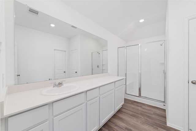 12206 English Mist Dr, Houston, TX 77044 - bathroom featuring a stall shower, vanity, wood finished floors, recessed lighting, and lofted ceiling