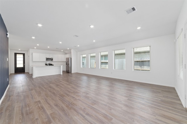 12206 English Mist Dr, Houston, TX 77044 - unfurnished living room featuring light wood-style flooring, baseboards, and recessed lighting