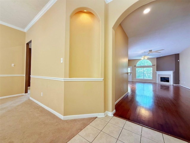 16322 E Amber Willow Trl, Cypress, TX 77433 - hall featuring baseboards, tile patterned floors, arched walkways, ornamental molding, and carpet floors
