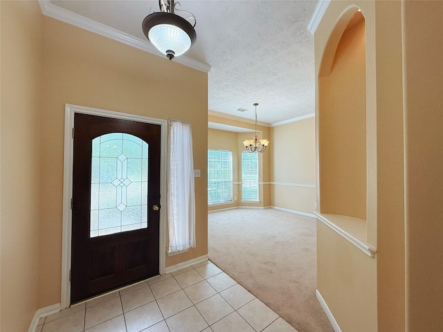 16322 E Amber Willow Trl, Cypress, TX 77433 - foyer entrance with light colored carpet, a chandelier, crown molding, baseboards, and light tile patterned flooring
