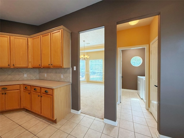 16322 E Amber Willow Trl, Cypress, TX 77433 - kitchen featuring a chandelier, light tile patterned floors, light countertops, baseboards, and backsplash