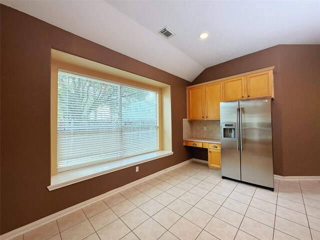 16322 E Amber Willow Trl, Cypress, TX 77433 - kitchen featuring stainless steel fridge with ice dispenser, tasteful backsplash, vaulted ceiling, baseboards, and light tile patterned floors