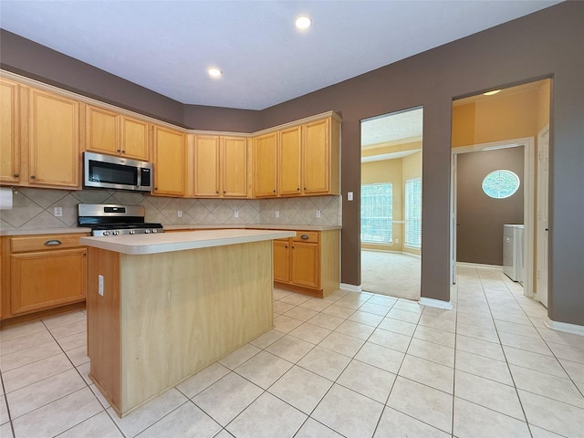 16322 E Amber Willow Trl, Cypress, TX 77433 - kitchen featuring appliances with stainless steel finishes, light tile patterned floors, light countertops, washer / clothes dryer, and recessed lighting