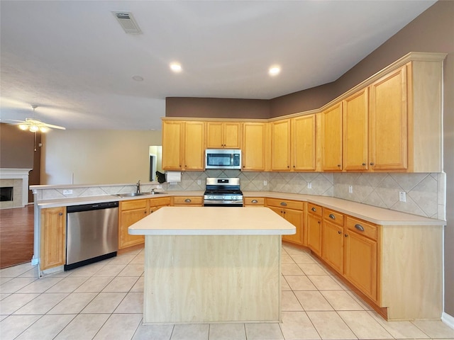 16322 E Amber Willow Trl, Cypress, TX 77433 - kitchen with stainless steel appliances, a peninsula, ceiling fan, a sink, and light countertops