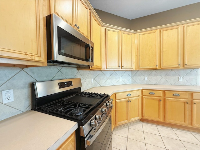 16322 E Amber Willow Trl, Cypress, TX 77433 - kitchen with stainless steel appliances, light countertops, light brown cabinetry, light tile patterned floors, and backsplash