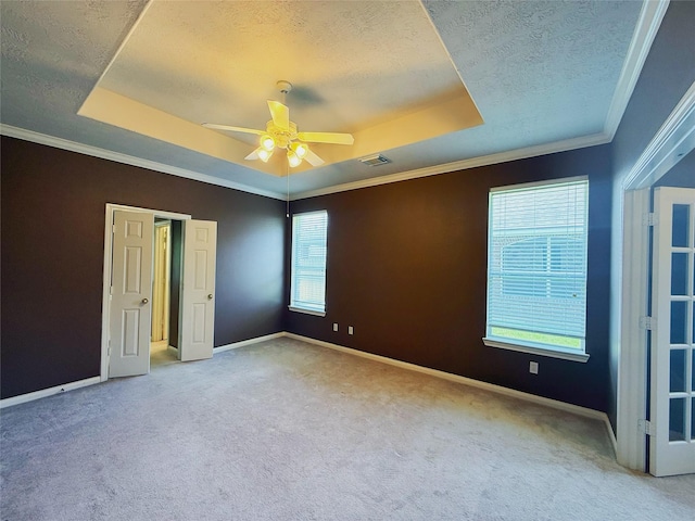 16322 E Amber Willow Trl, Cypress, TX 77433 - unfurnished bedroom featuring a raised ceiling, carpet floors, a textured ceiling, baseboards, and ornamental molding