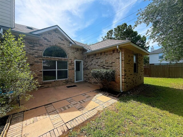16322 E Amber Willow Trl, Cypress, TX 77433 - rear view of property featuring roof with shingles, a patio, and brick siding
