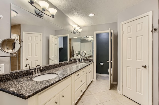 15335 Poplar Grove Dr, Houston, TX 77068 - full bathroom featuring a textured ceiling, tile patterned floors, double vanity, toilet, and baseboards
