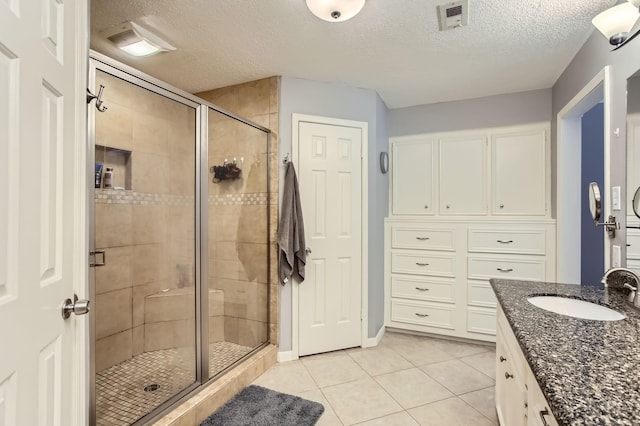 15335 Poplar Grove Dr, Houston, TX 77068 - bathroom with a textured ceiling, a stall shower, tile patterned flooring, and vanity