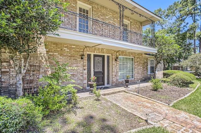15335 Poplar Grove Dr, Houston, TX 77068 - view of exterior entry with a balcony, brick siding, and covered porch