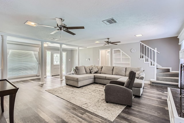 15335 Poplar Grove Dr, Houston, TX 77068 - living area featuring ornate columns, ceiling fan, wood finished floors, stairway, and a textured ceiling