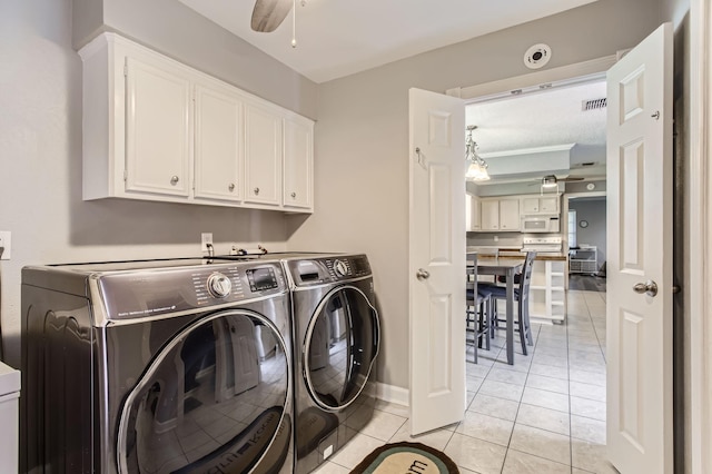 15335 Poplar Grove Dr, Houston, TX 77068 - washroom featuring washer and dryer, cabinet space, light tile patterned floors, a ceiling fan, and baseboards