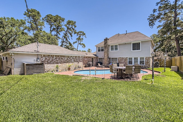 15335 Poplar Grove Dr, Houston, TX 77068 - back of house with brick siding, a patio area, and a chimney