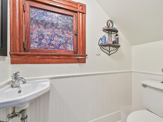 1515 24th St, Galveston, TX 77550 - bathroom featuring vaulted ceiling, toilet, and a sink