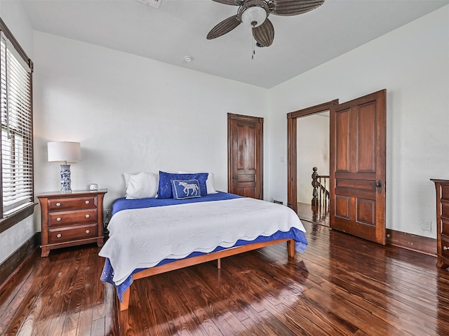 1515 24th St, Galveston, TX 77550 - bedroom with wood finished floors, a ceiling fan, and baseboards