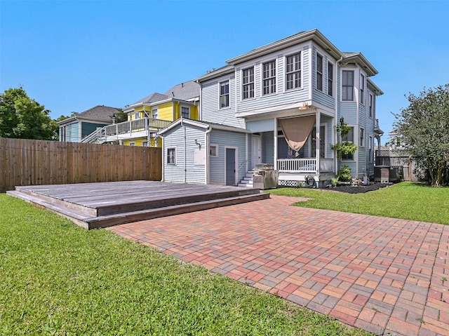 1515 24th St, Galveston, TX 77550 - back of property with a wooden deck, a porch, and a patio area